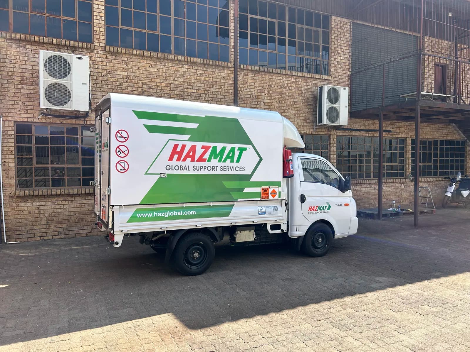 Hazmat branded Hyundai H-100 side view