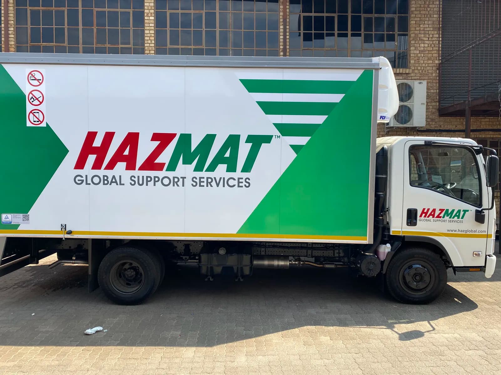 Hazmat branded Isuzu truck alternate side view